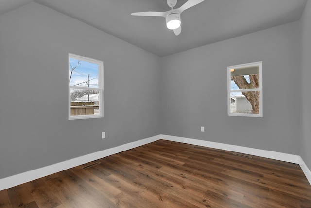 unfurnished room featuring dark hardwood / wood-style floors, a wealth of natural light, and ceiling fan