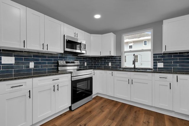 kitchen featuring sink, dark wood-type flooring, white cabinets, and appliances with stainless steel finishes