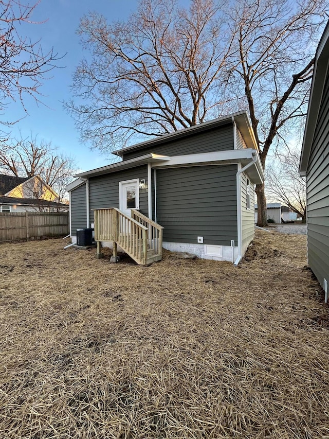 rear view of property with central AC