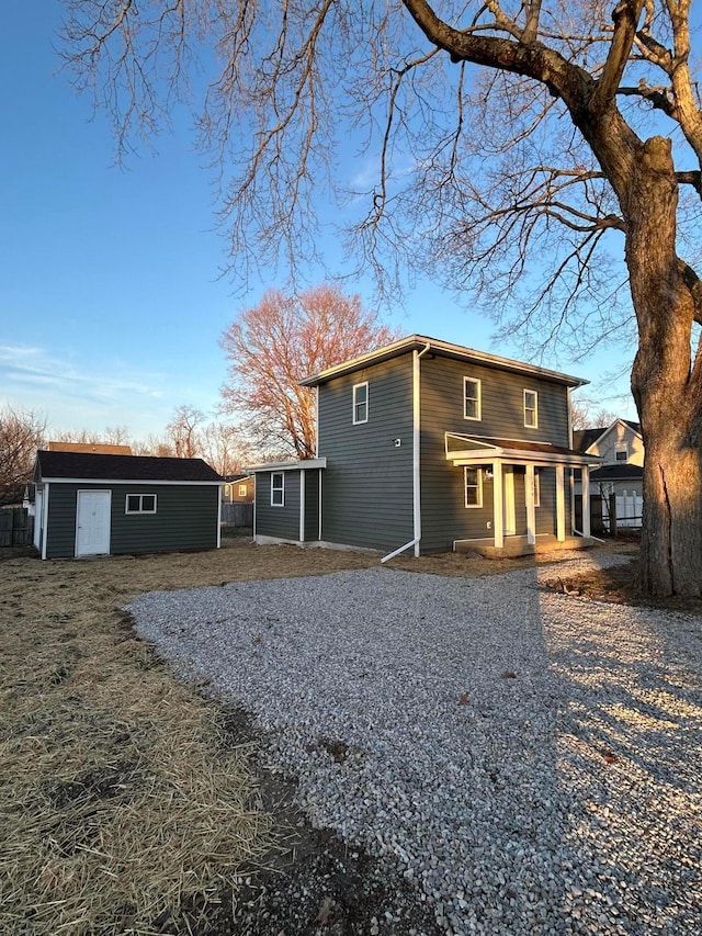 back of property with an outbuilding