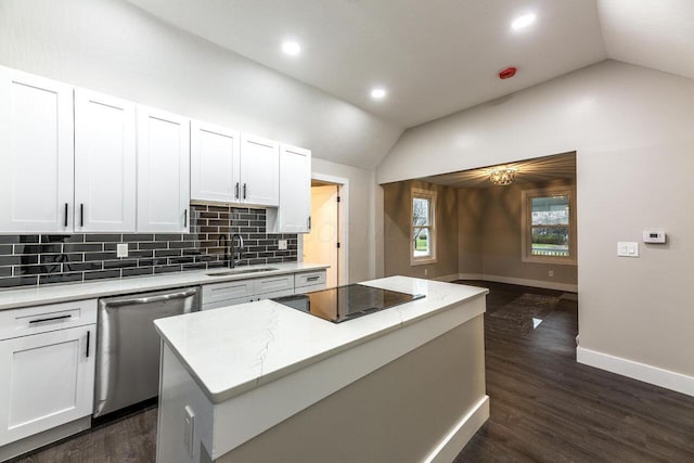 kitchen with a center island, sink, vaulted ceiling, stainless steel dishwasher, and white cabinetry