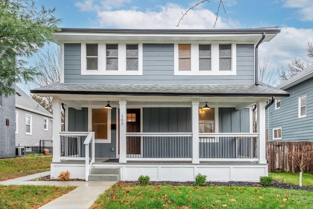 view of front of property with a porch and cooling unit