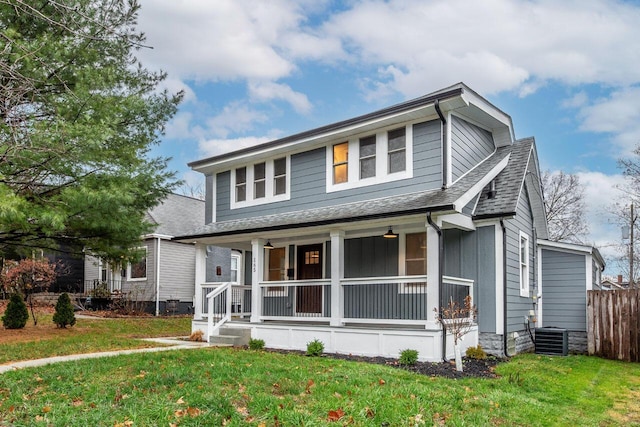 view of front facade featuring a front lawn and central AC unit