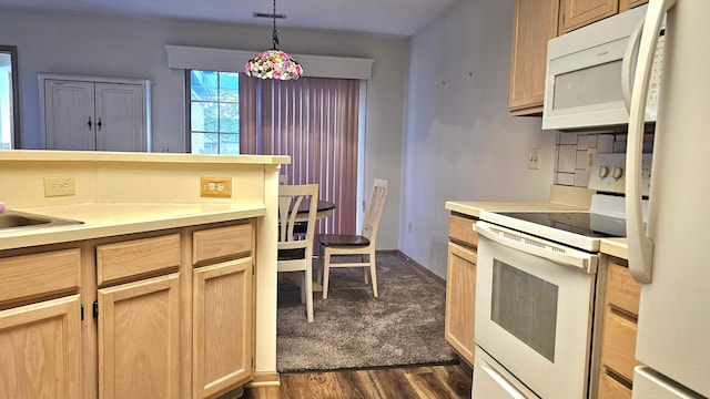 kitchen with light brown cabinetry, white appliances, decorative light fixtures, and dark hardwood / wood-style floors