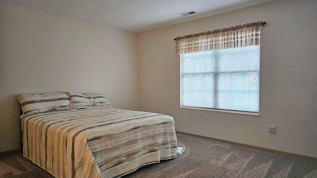 carpeted bedroom with multiple windows