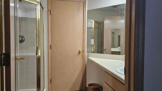 bathroom with vanity and a shower with shower door