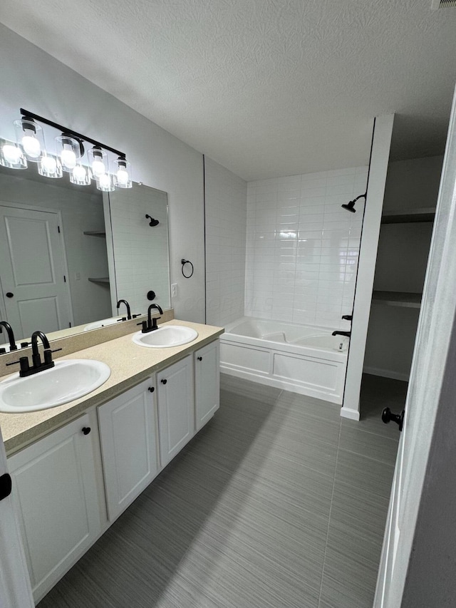 bathroom with vanity and a textured ceiling