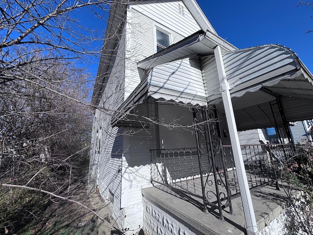 view of side of property featuring a porch