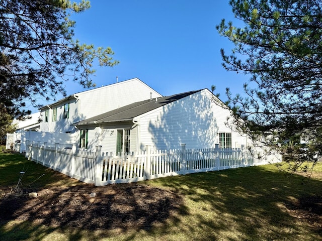 rear view of house with a lawn