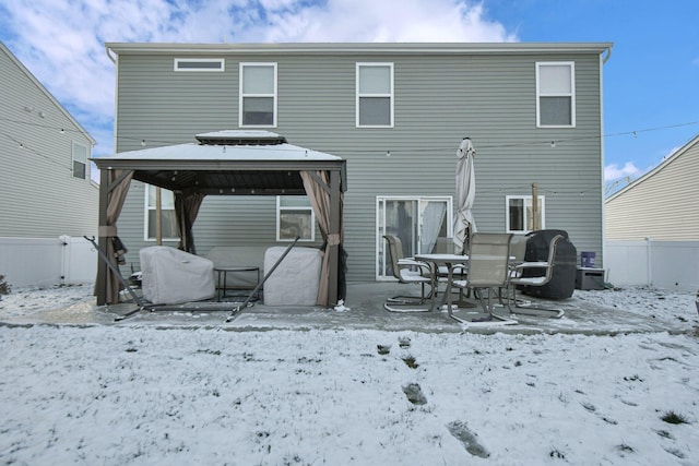 view of snow covered back of property