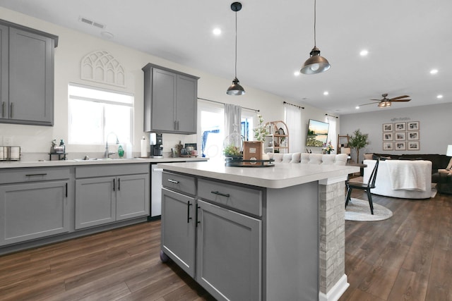 kitchen with gray cabinetry, ceiling fan, sink, dark hardwood / wood-style flooring, and decorative light fixtures