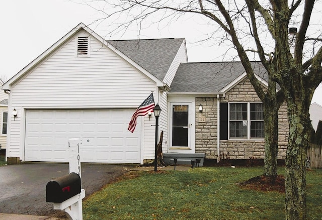 view of front of property with a garage and a front lawn