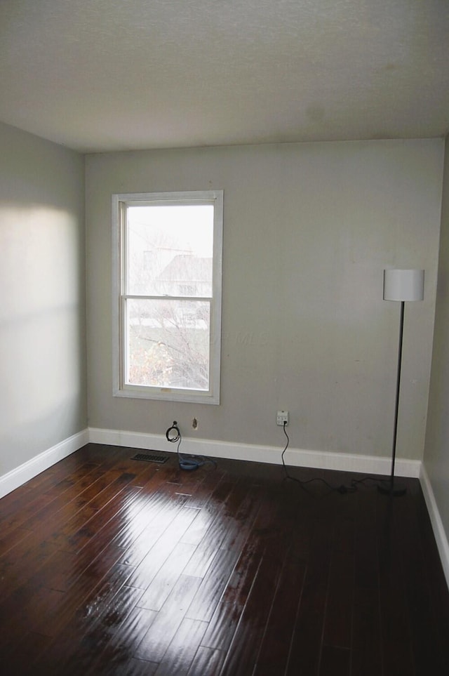 empty room featuring dark hardwood / wood-style flooring