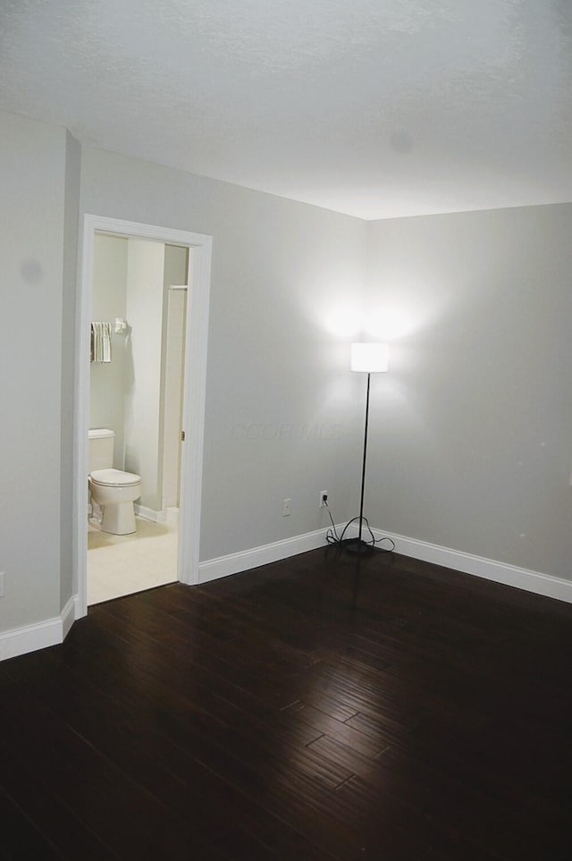 spare room with hardwood / wood-style flooring