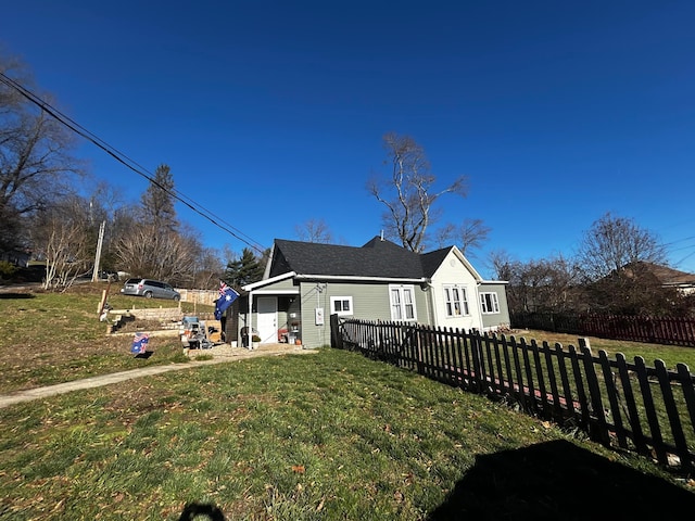 view of front of property featuring a garage and a front lawn