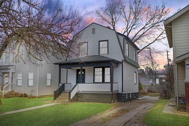 view of front of home with a yard and covered porch