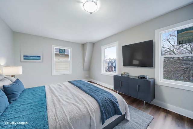 bedroom with dark hardwood / wood-style flooring