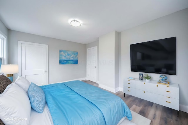 bedroom with dark hardwood / wood-style floors