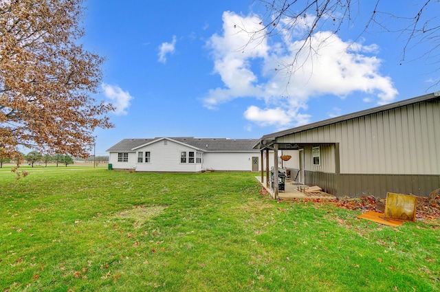 rear view of house with a yard and a patio