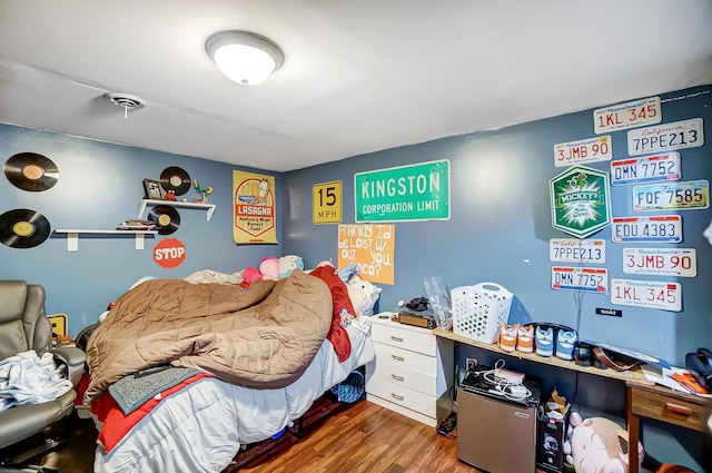 bedroom with hardwood / wood-style floors