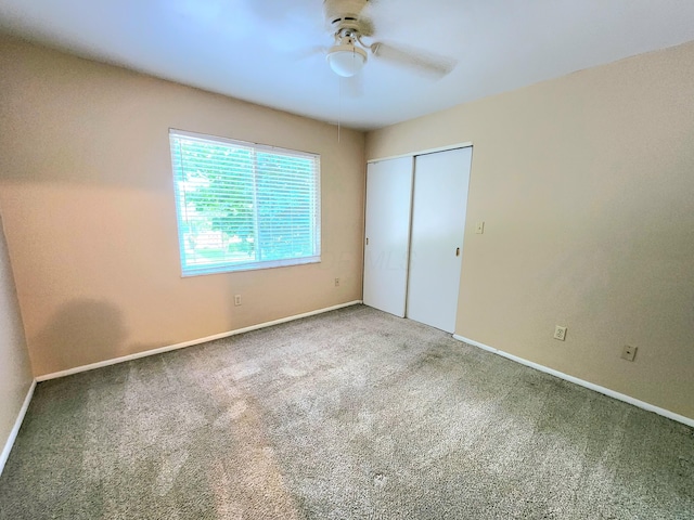 unfurnished bedroom featuring carpet, a closet, and ceiling fan