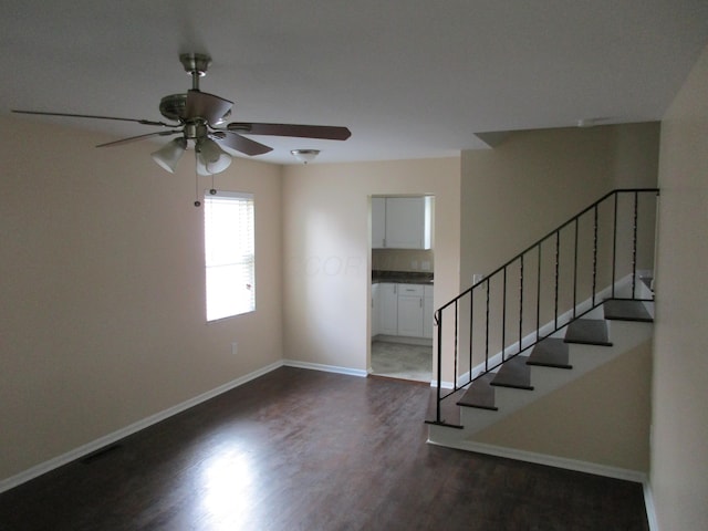 entryway with ceiling fan and dark wood-type flooring