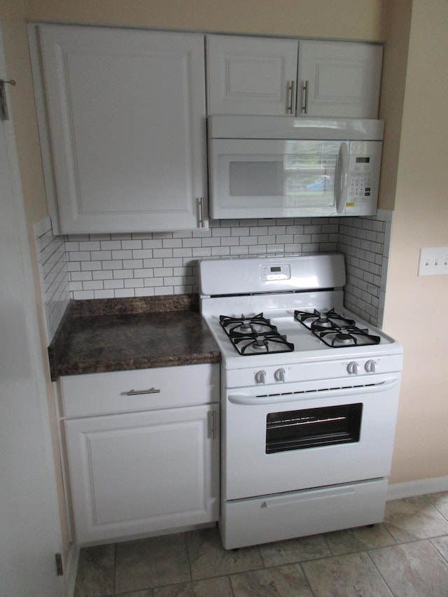 kitchen with decorative backsplash, white cabinetry, light tile patterned flooring, and white appliances