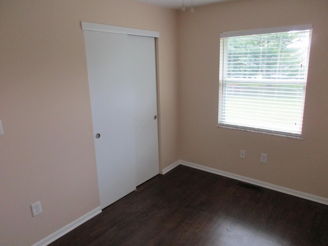 empty room featuring dark wood-type flooring