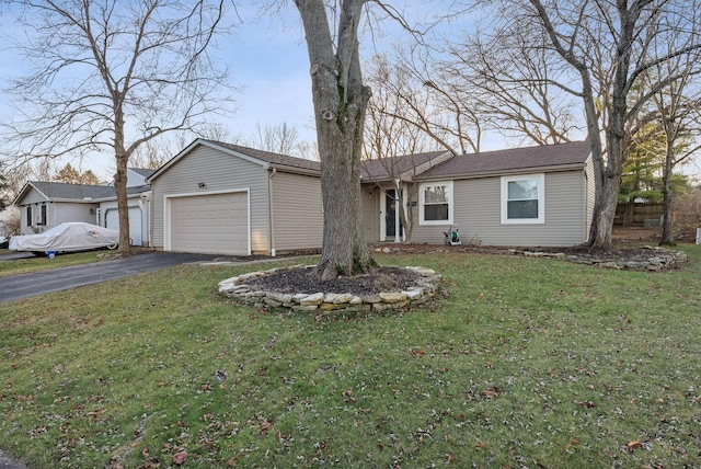 single story home featuring a garage and a front lawn