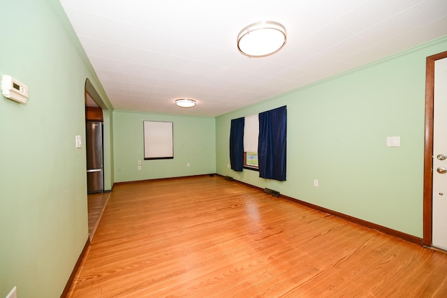 unfurnished room with light hardwood / wood-style flooring