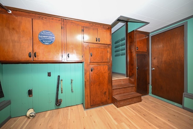 laundry area featuring cabinets and light wood-type flooring