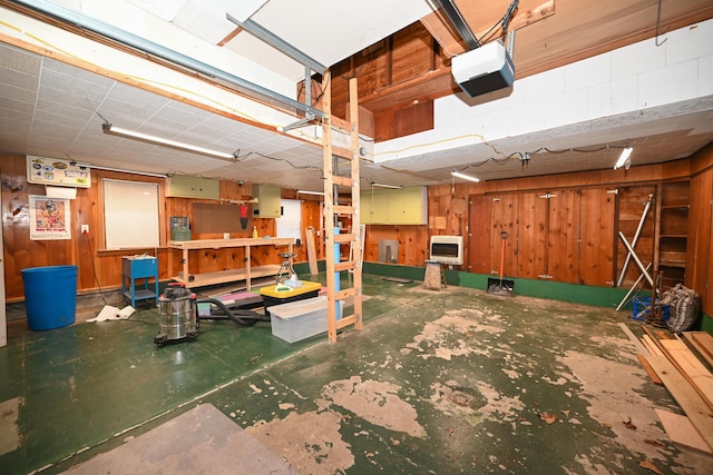 basement with heating unit, electric panel, and wooden walls