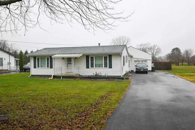 ranch-style house featuring a garage and a front lawn