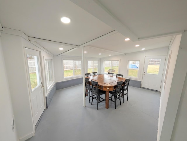 dining area featuring vaulted ceiling with beams