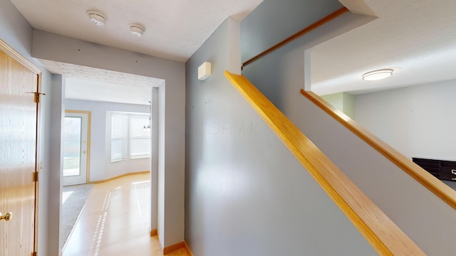 hallway with a textured ceiling