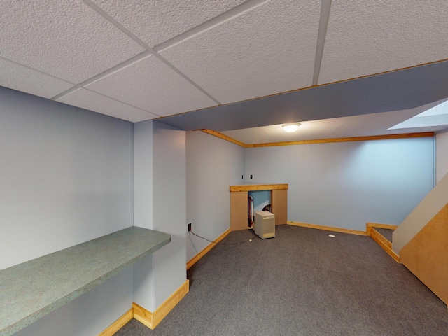 basement featuring carpet flooring and a paneled ceiling