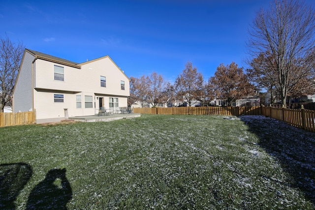 rear view of house with a yard and a patio