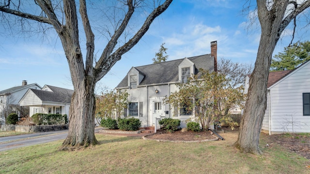 cape cod house with a front lawn