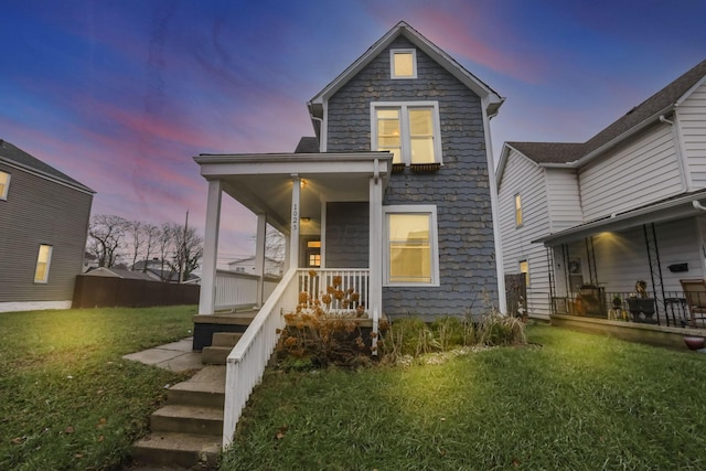 view of front of property with a yard and covered porch