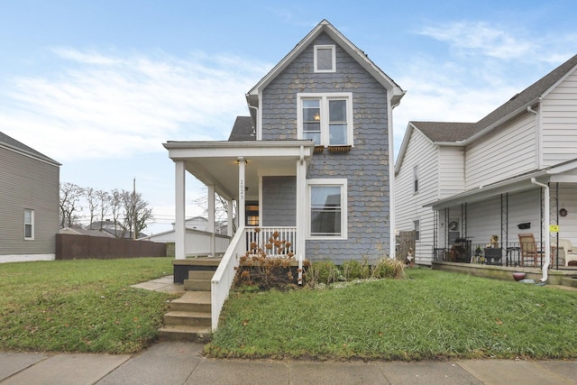 view of front of home with covered porch and a front yard