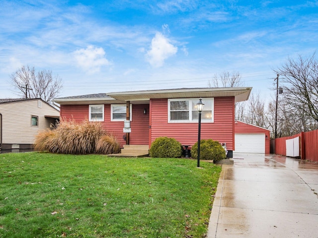 view of front of property featuring a front yard and a garage