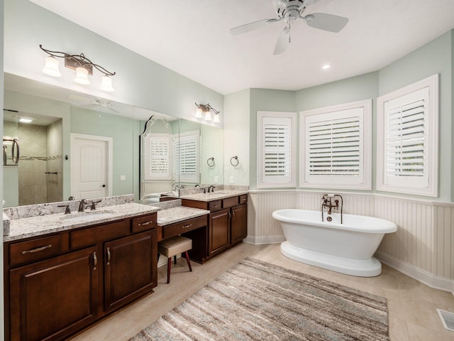 bathroom featuring vanity, ceiling fan, and independent shower and bath