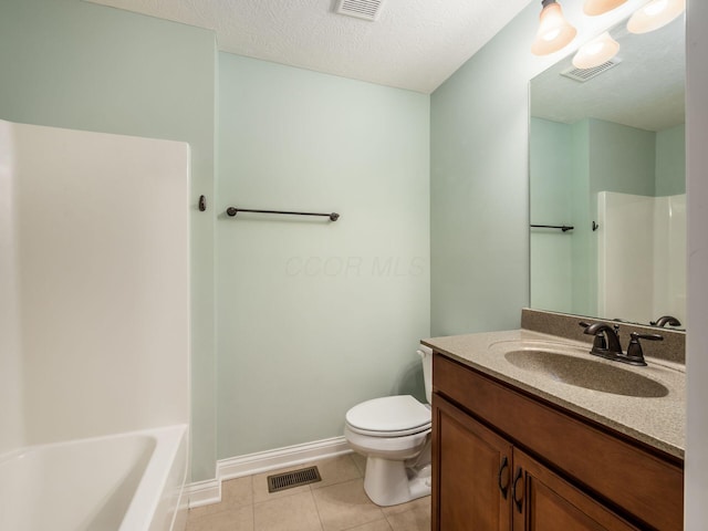 bathroom featuring a textured ceiling, tile patterned flooring, vanity, and toilet