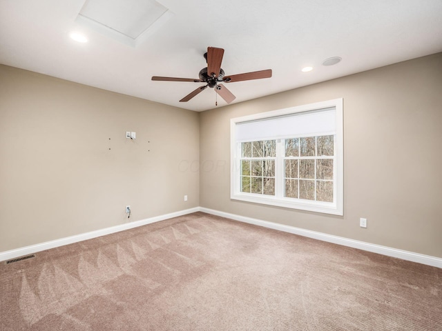 spare room with ceiling fan and carpet