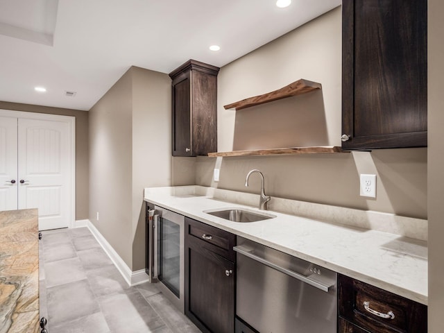 kitchen with dishwasher, wine cooler, light stone counters, sink, and dark brown cabinets