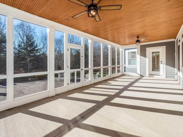 unfurnished sunroom with ceiling fan and wood ceiling