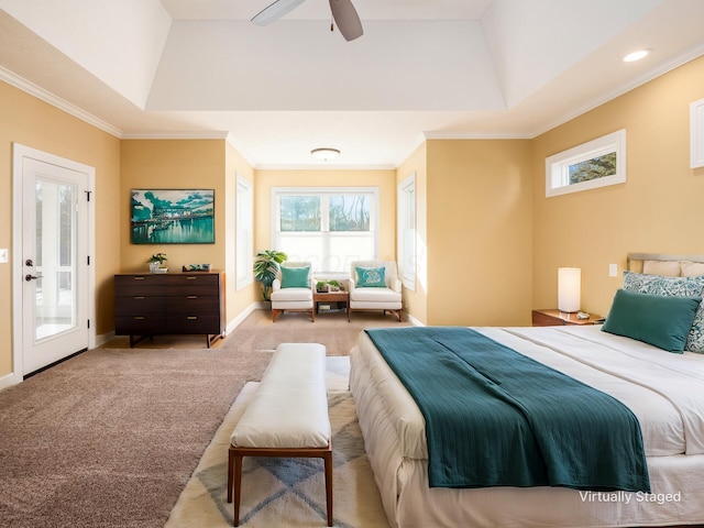 bedroom featuring ceiling fan, crown molding, a raised ceiling, and carpet floors