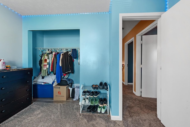 carpeted bedroom featuring a closet and a textured ceiling