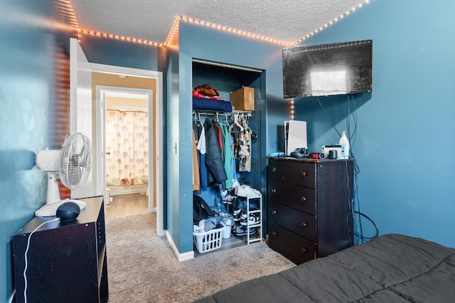 carpeted bedroom featuring a textured ceiling and a closet