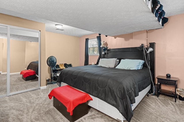 bedroom featuring carpet and a textured ceiling